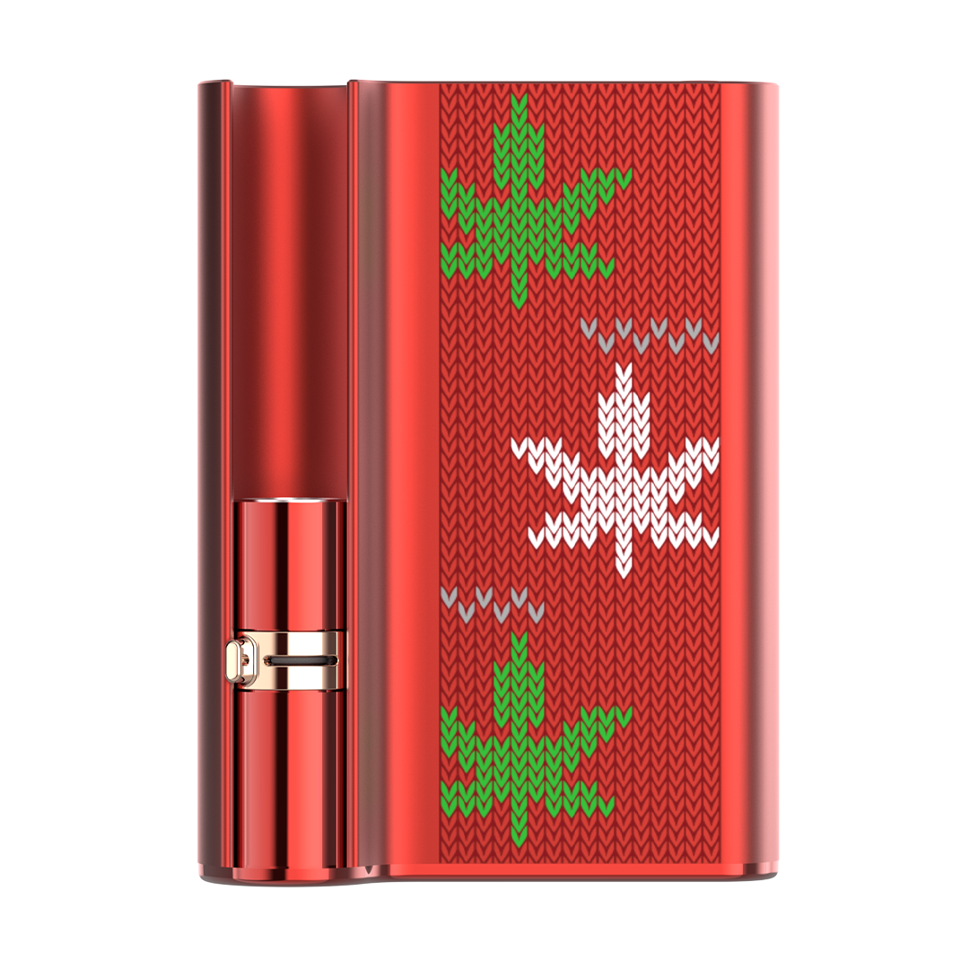 The CCELL Palm Pro Christmas Edition, featuring a festive matte red body contrasted with a deep green and white marijuana leaves. This view highlights the unique side-mounted, variable voltage control switch.