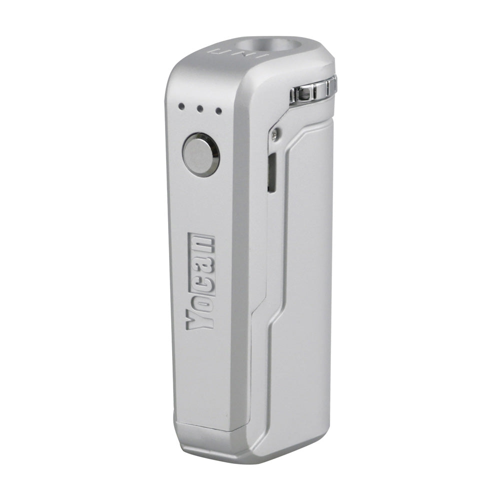 A front-angle profile of the Yocan UNI in Silver. This unit is finished in a sleek, brushed metallic silver that gives it a clean, premium appearance. The shot highlights the universal cartridge chamber and the side-mounted micro-USB charging port on its compact, durable frame.