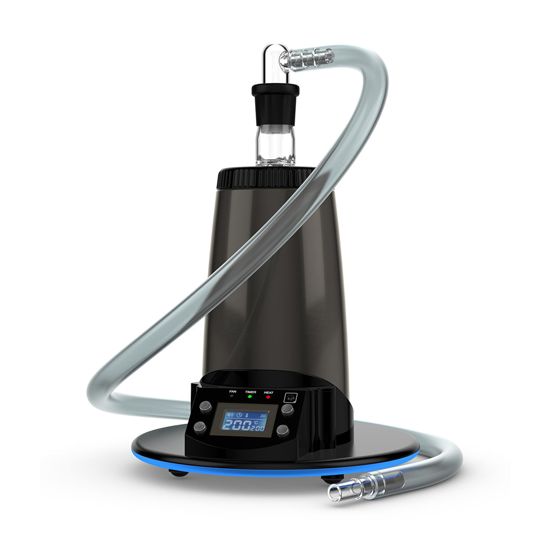 A crisp, front-facing studio product shot of the Arizer Extreme Q Desktop Vaporizer configured with its 3-foot silicone whip system. The flexible, premium frosted silicone tubing attaches directly to the top chamber via a 360-degree swiveling borosilicate glass elbow adapter, showcasing the direct-draw setup designed for traditional, relaxed tabletop sessions.