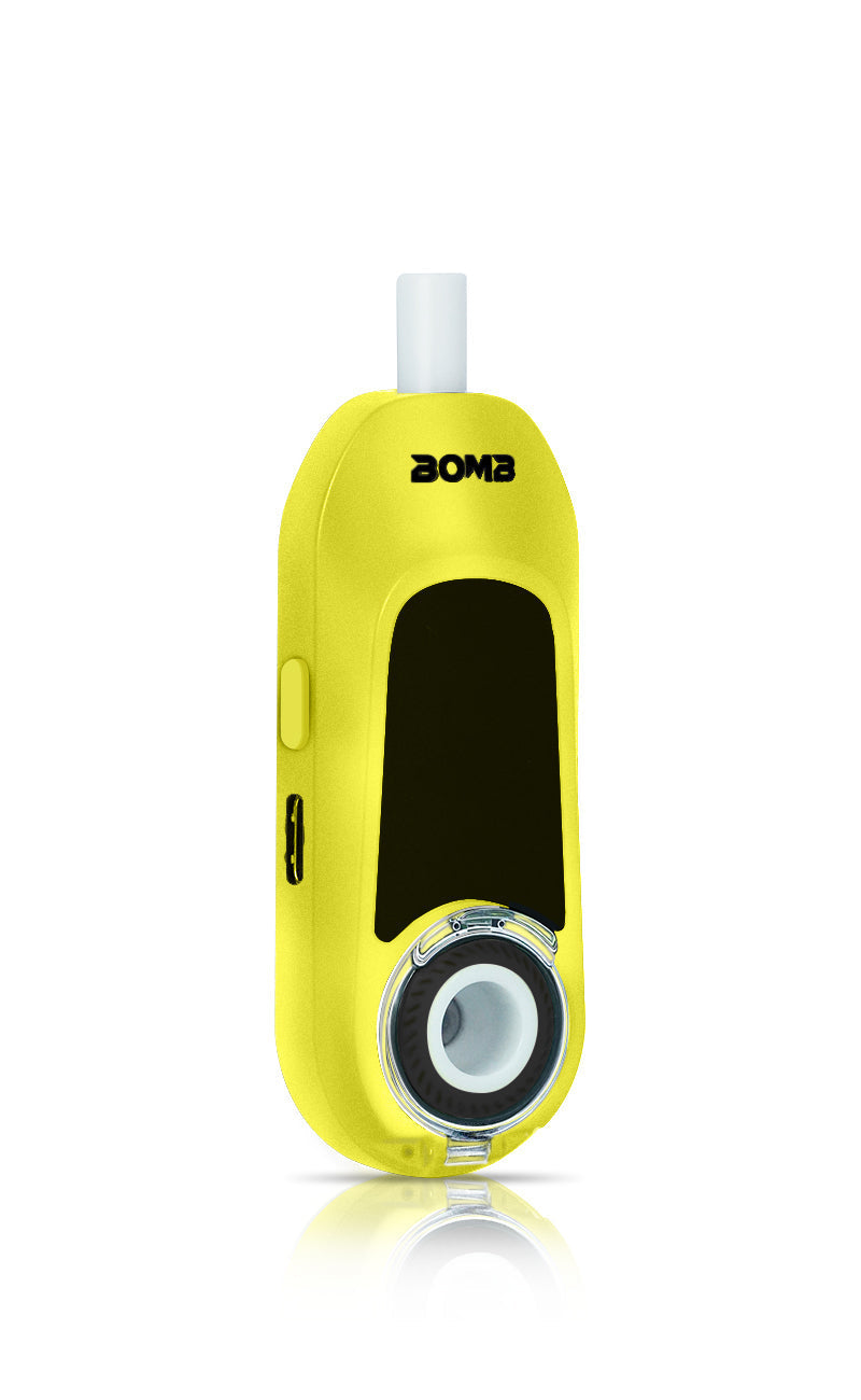 An angled front view of the Bomb x VapX Magic Bean Liquid Lemon, showing the ergonomic curve of the vibrant yellow chassis. The shot provides a clear view of the recessed ceramic heating chamber and the polished interface.