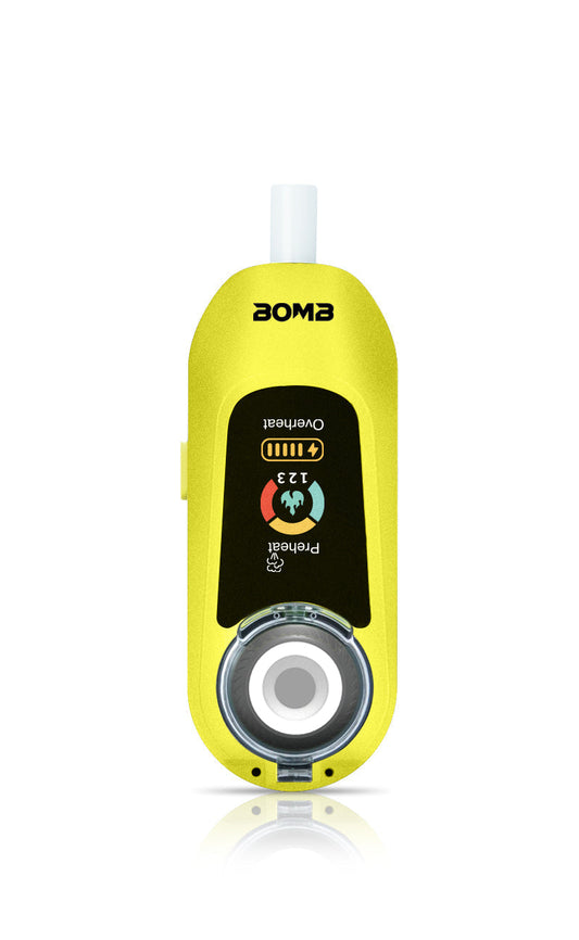 A front-facing view of the Liquid Lemon Bomb × VapX Magic Bean. This shot highlights the vibrant yellow silicone body, the recessed ceramic heating bowl, and the bright lit digital display screen.