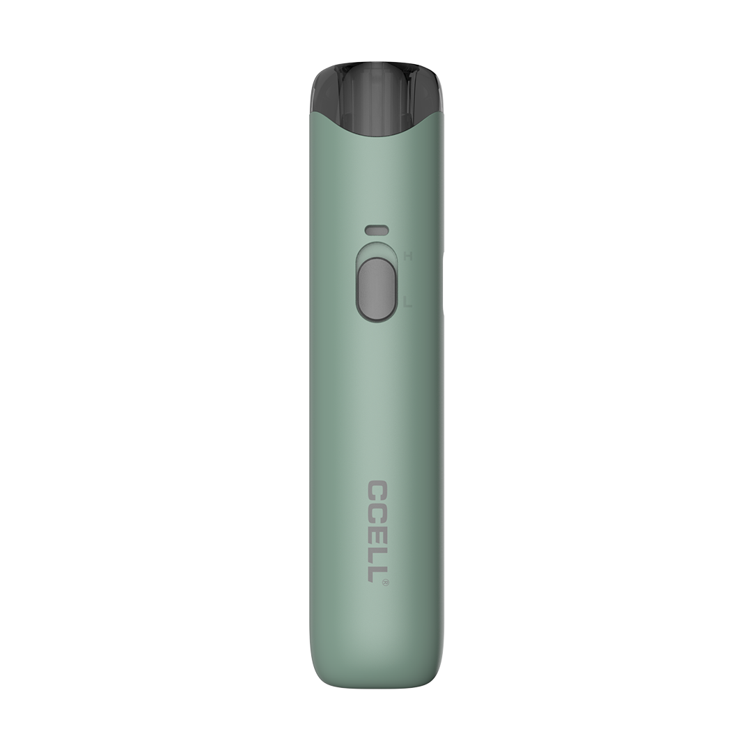 A front-facing vertical shot of the CCELL Go Stik 510 Battery in Emerald Green. This version features a solid, muted sage-green matte finish. The image showcases the sleek, oval-shaped body, the grey "H/L" voltage slider, and the silver CCELL branding. A semi-transparent dark grey mouthpiece is visible at the top, illustrating the device's compatibility with standard 510 cartridges.