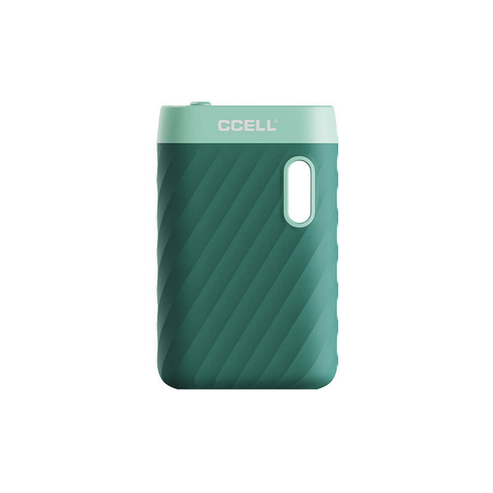 A front-facing studio profile shot of the CCELL Sandwave in Marine Green. The device features a soft, pastel seafoam teal-green matte finish that highlights the ergonomic, ridged wave patterns along the outer grip and the top-mounted mechanical voltage toggle switch.