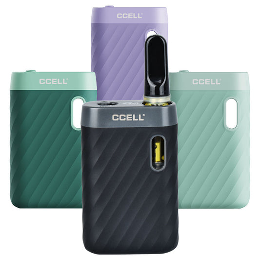 A group presentation displaying the CCell Sandwave color lineup. Standing side-by-side from left to right are the Midnight Black variant (shown with a clear glass 510-thread oil cartridge installed in the magnetic port), Marine Green, Lavender, and Mint Green, highlighting the vibrant pastel tones and the uniform wavy grip texture across the collection.