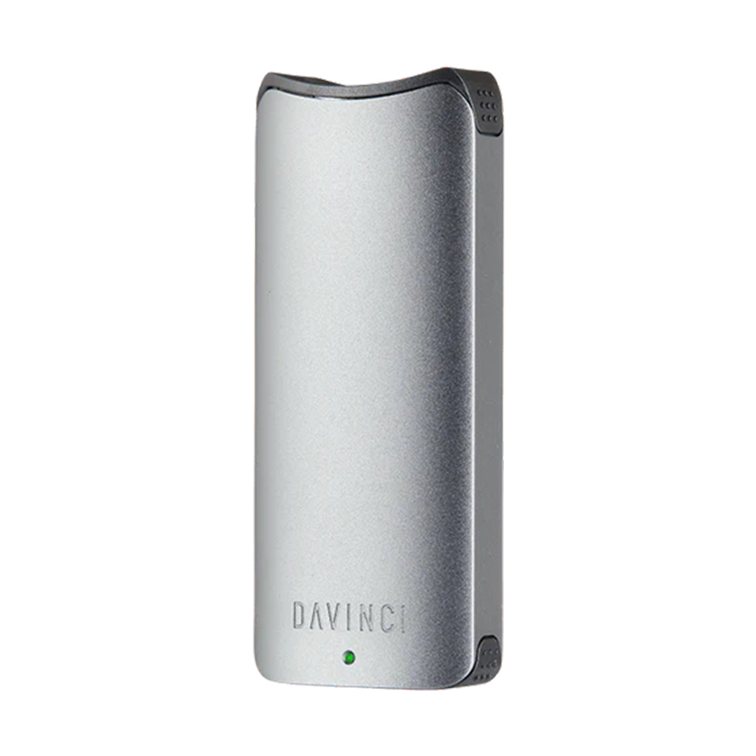 A front-facing studio shot of the DaVinci ARTIQ in Gray. The device features a sleek, matte space-gray anodized aluminum finish across its vertical rectangular body, highlighting its smooth corners, a single centralized LED indicator light, and the ergonomic top mouthpiece.