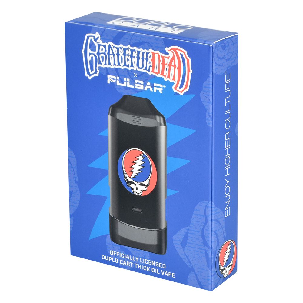 A direct, front-facing studio product shot of the official Grateful Dead x Pulsar DuploCart retail box. The vibrant packaging prominently features authentic Grateful Dead artwork, the classic typography logo, and clear product graphics of the dual-cartridge battery, making it instantly recognizable as a premium collector's piece.