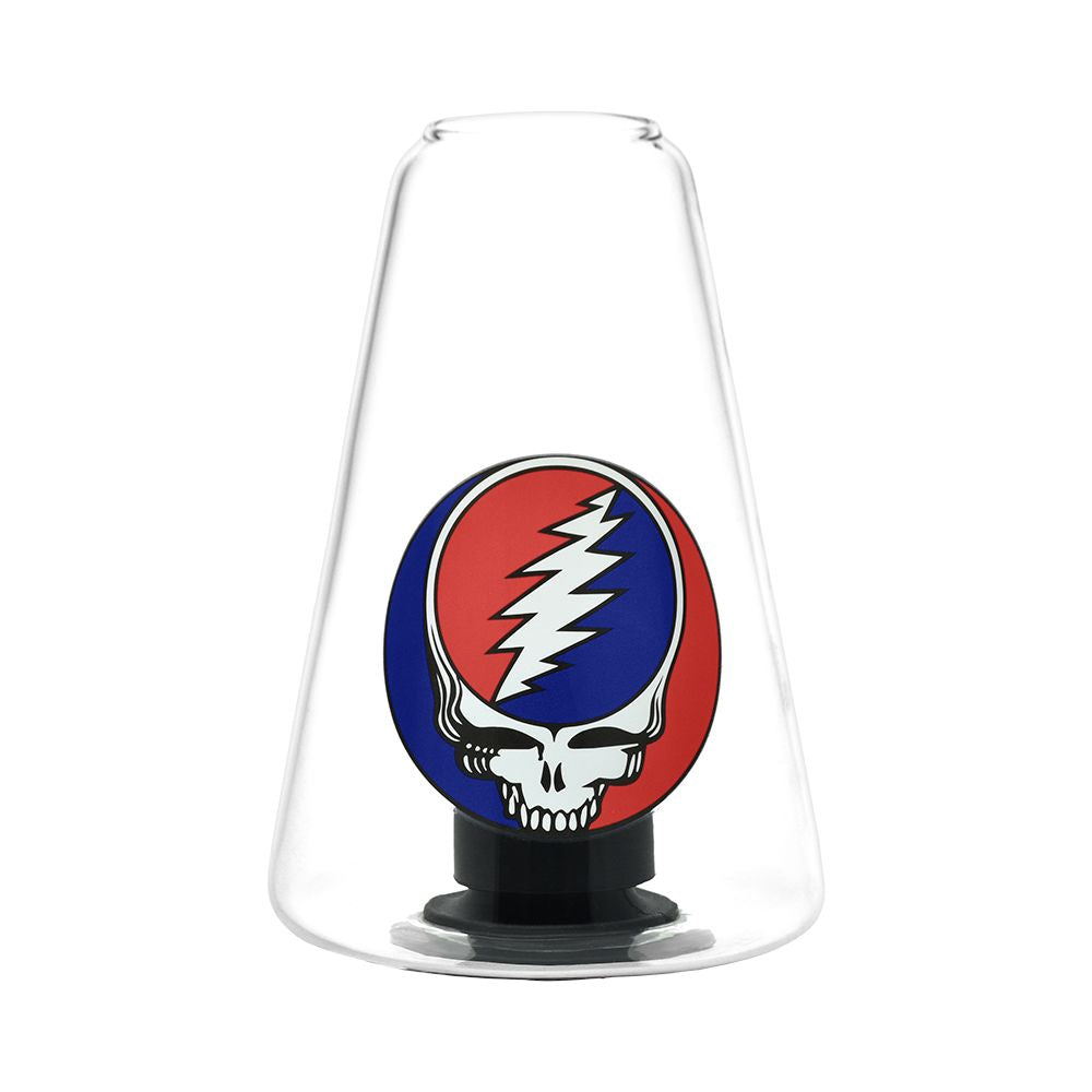 A tight, macro studio close-up focusing on the Grateful Dead x Pulsar Sipper glass dry cup. The image highlights the intricate, high-quality molding of the signature red and blue "Steal Your Face" skull emblem situated inside the glass, showing how vapor circulates around the artwork during an auto-fill session.