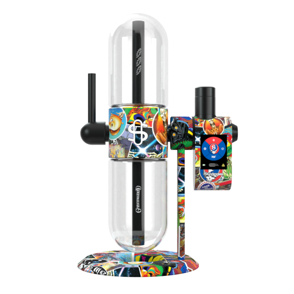 A crisp, front-facing studio shot displaying the Grateful Dead x Stündenglass Modül smart power base detached and installed directly onto the full-sized Grateful Dead x Stündenglass Gravity Infuser. This highlights the seamless compatibility of the digital convection heating engine as it mounts onto the iconic 360-degree rotating gravity glass infuser, with both matching in vibrant, licensed Legacy Patchwork artwork.