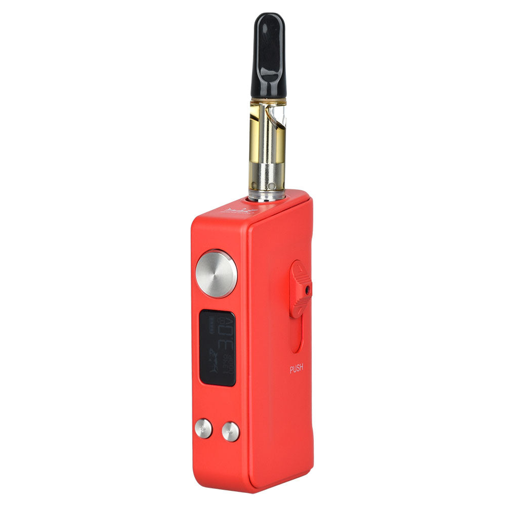 A studio shot of The Shiv in Matte Red with a 510-thread oil cartridge fully deployed. The mechanical thumb slider is pushed upward, exposing the top of a clear glass cartridge extended from the protective internal chamber, demonstrating the device in active use mode.