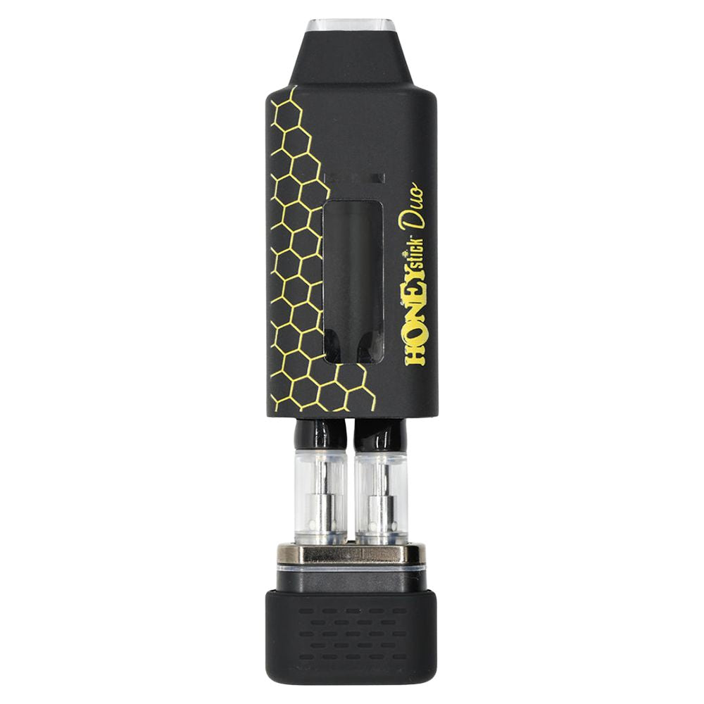 A detailed product shot of the HoneyStick DUO with its upper magnetic cover and mouthpiece assembly pulled halfway off. This perspective exposes the internal dual chamber design, clearly displaying two standard 510-threaded oil cartridges threaded side-by-side into the loading deck to showcase its custom-blending capacity.