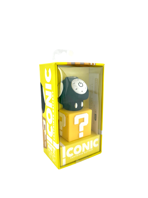 A clean, front-facing product shot of the Iconic Mushroom Cartridge Battery in Black presented in its retail packaging. The unit showcases a sleek, glossy black cap adorned with bold white spots resting over the clean white lower body, neatly displayed inside its custom-fit window box.