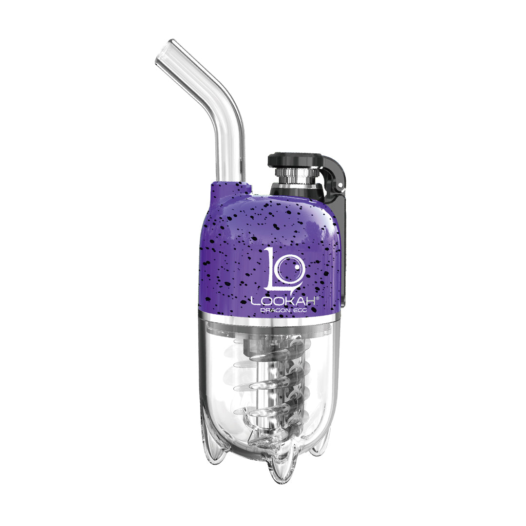 A clean, front-facing studio product shot showcasing the LOOKAH Dragon Egg Vaporizer in the bold Purple-Black Spatter colorway. The upper zinc-alloy power frame is coated in a deep royal purple base layered with a heavy, textured black paint splatter design, sitting securely atop the transparent, food-grade perspex water bubbler base.