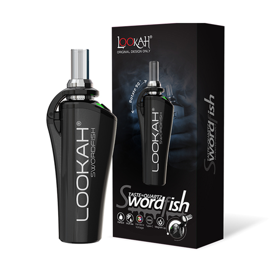 A studio product shot displaying the LOOKAH Swordfish Wax Dab Pen Vaporizer in Black standing next to its branded retail box, highlighting the ergonomic metallic body, clear glass mouthpiece, and magnetic top hinge.