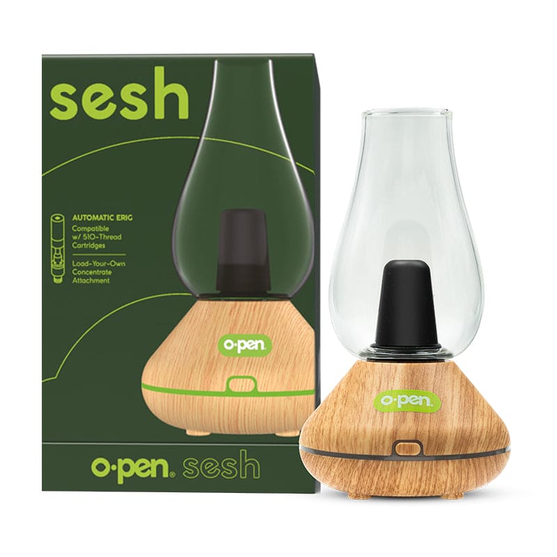 The O.pen Sesh Electric Dab Rig in Oak displayed next to its official retail packaging. This shot emphasizes the "Automatic E-Rig" branding and reinforces the device's dual compatibility with 510-thread cartridges and concentrate attachments for a versatile dabbing experience.