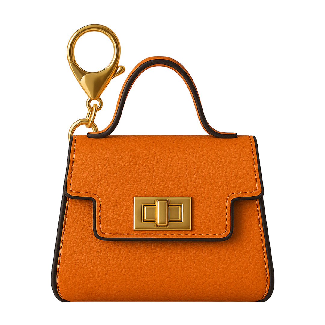 Front view of a closed, mini orange leather satchel-style 510 vape battery holder with a gold flip lock and keychain.