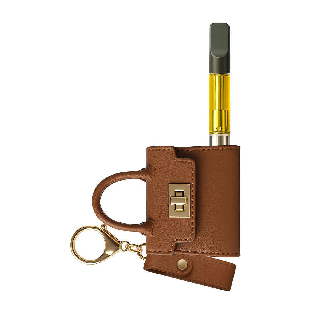 Discrete Penjamin Pursejamin vape battery in classic cognac brown leather, appearing as a miniature designer purse keychain with a 510-threaded connection for oil cartridges.