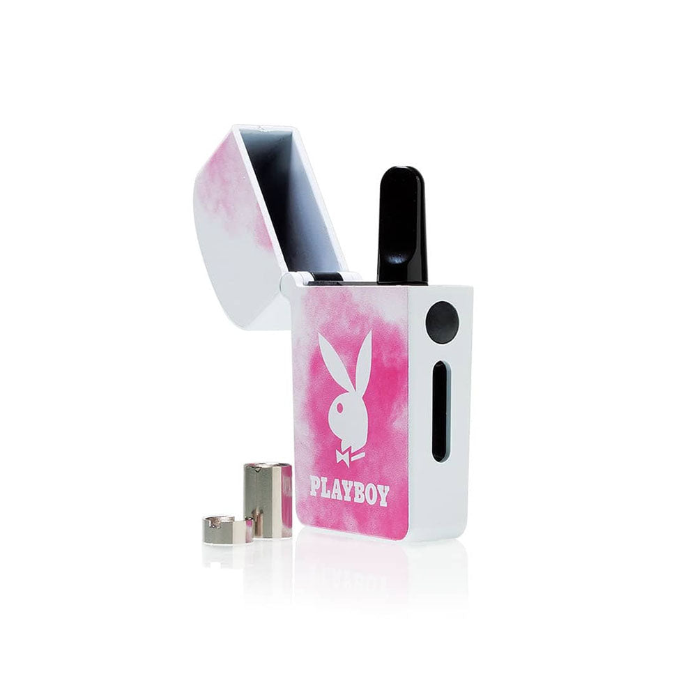 A detailed studio product shot of the Playboy x RYOT VERB 510 vape battery in Pink Smoke with its top lid flipped completely open. The internal compartment shows an installed 510 oil cartridge, while the included short and medium magnetic thread adapters rest clearly on the surface right next to the device base.