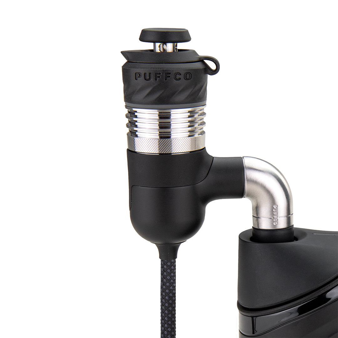 A detailed close-up studio shot highlighting the Puffco Peak Pro Link adapter fitting flush inside the Peak Pro base chamber housing. The photo captures the tight, seamless connection between the electronic link adapter interface and the power base unit, demonstrating the secure locking mechanism.