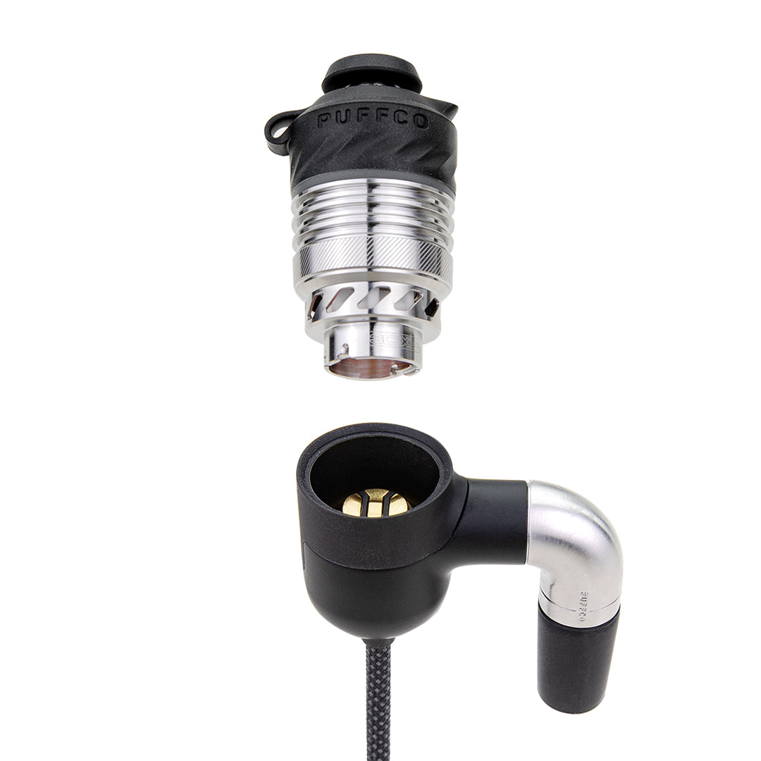 A detailed, close-up studio shot highlighting the Puffco Peak Pro Link rig adapter with a 3D heating atomizer hovering right above it. The angle captures the precise geometric layout of the electronic connection port, emphasizing how the chamber locks securely into the link arm assembly above the joint sleeve.
