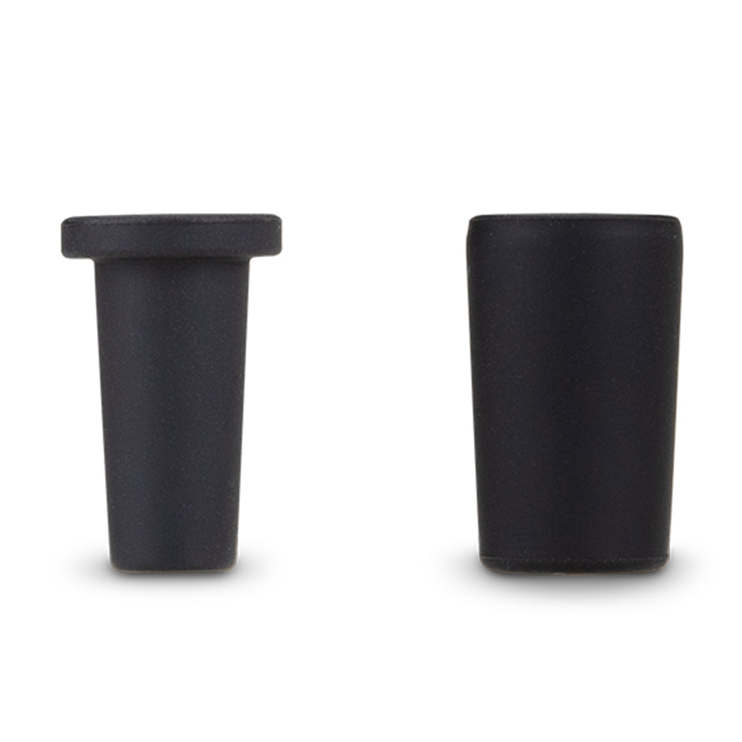 A crisp close-up studio shot displaying the interchangeable 10mm and 14mm silicone joint adapter sleeves alongside the weighted desktop rest stand for the Puffco Peak Pro Link. The layout highlights the precise rubber fitting sleeves that allow for airtight compatibility with standard water pipe glass joints.