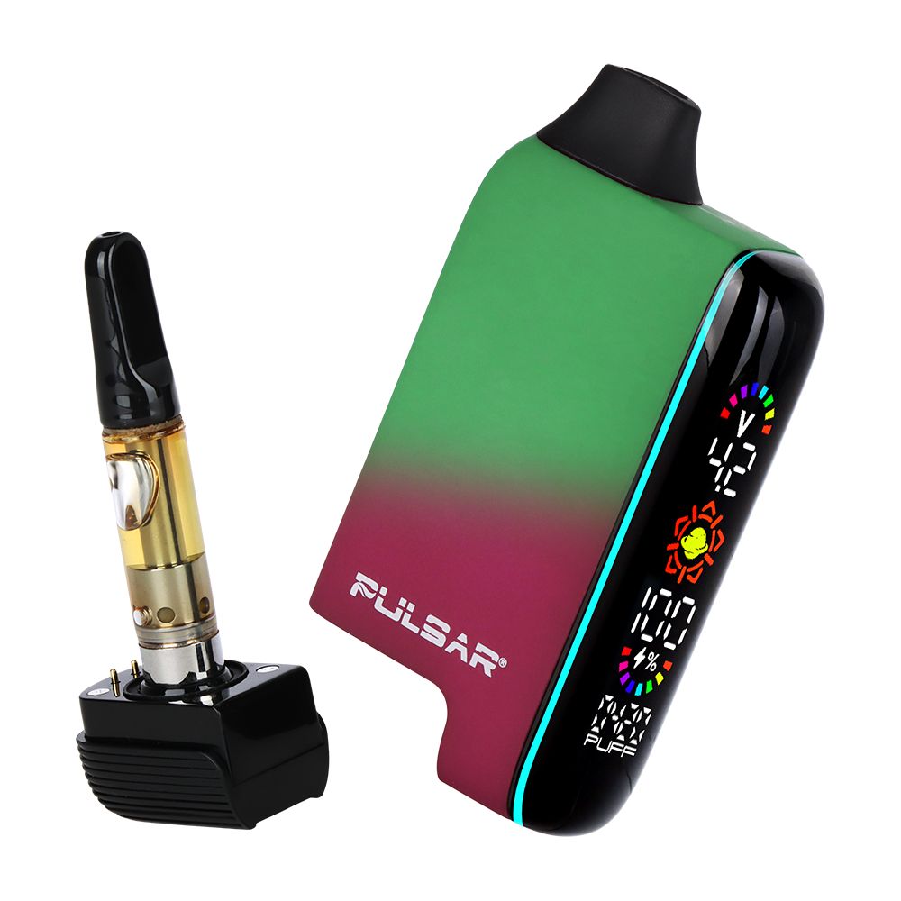 Pulsar 510 DL 5.0 Thermo in Fairy Fire, shown with the magnetic base detached to reveal a 510 cartridge. The device is in a mid-color transition (pink to green) with the LCD screen active.