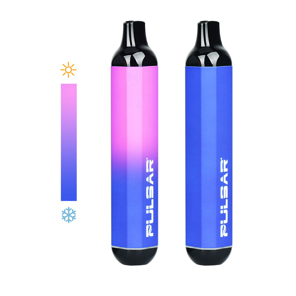 A clean studio product shot featuring two Pulsar 510 DL Thermo devices in the Blue Pink colorway side-by-side. The bar device on the right rests in its fully cold state, showcasing a solid, uniform royal blue body. The device on the left displays a mid-session thermal transition, with its upper portion dynamically shifting to a bright, vibrant hot pink color from heat exposure.