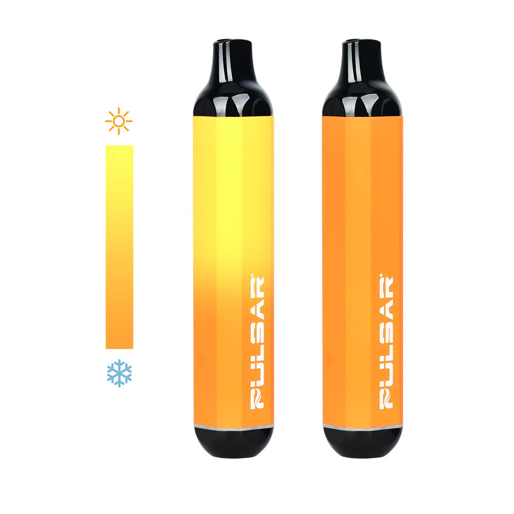 A detailed product shot focusing on two Pulsar 510 DL Thermo devices in the Orange Yellow colorway side-by-side. The device on the right is in its fully cold state, displaying a solid, uniform matte orange body. The device on the left demonstrates a half-thermal transition, showing the upper half of the bar body dynamically shifting to a bright yellow hue from heat exposure.