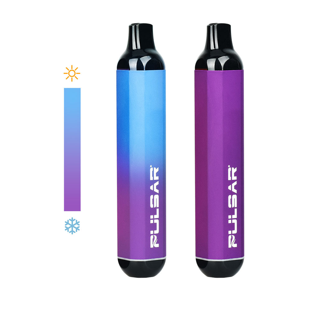A clean studio product shot featuring two Pulsar 510 DL Thermo devices in the Purple Blue colorway side-by-side. The device on the right rests in its fully cold state, displaying a solid, deep matte purple body. The device on the left shows a mid-session thermal transition, with its upper half dynamically shifting to a bright electric blue from heat exposure.