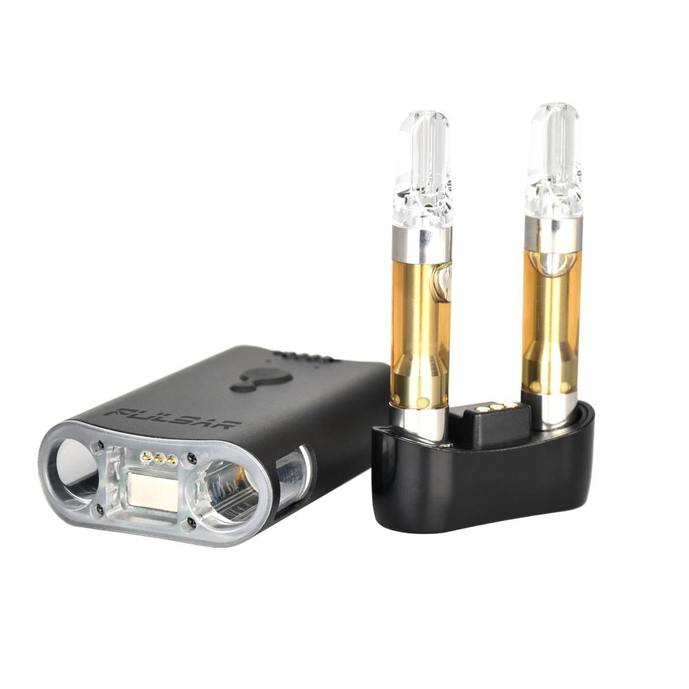 Pulsar DuploCart components laid out, showing two oil cartridges installed on the magnetic 510-thread base next to the removable vaporizer body.