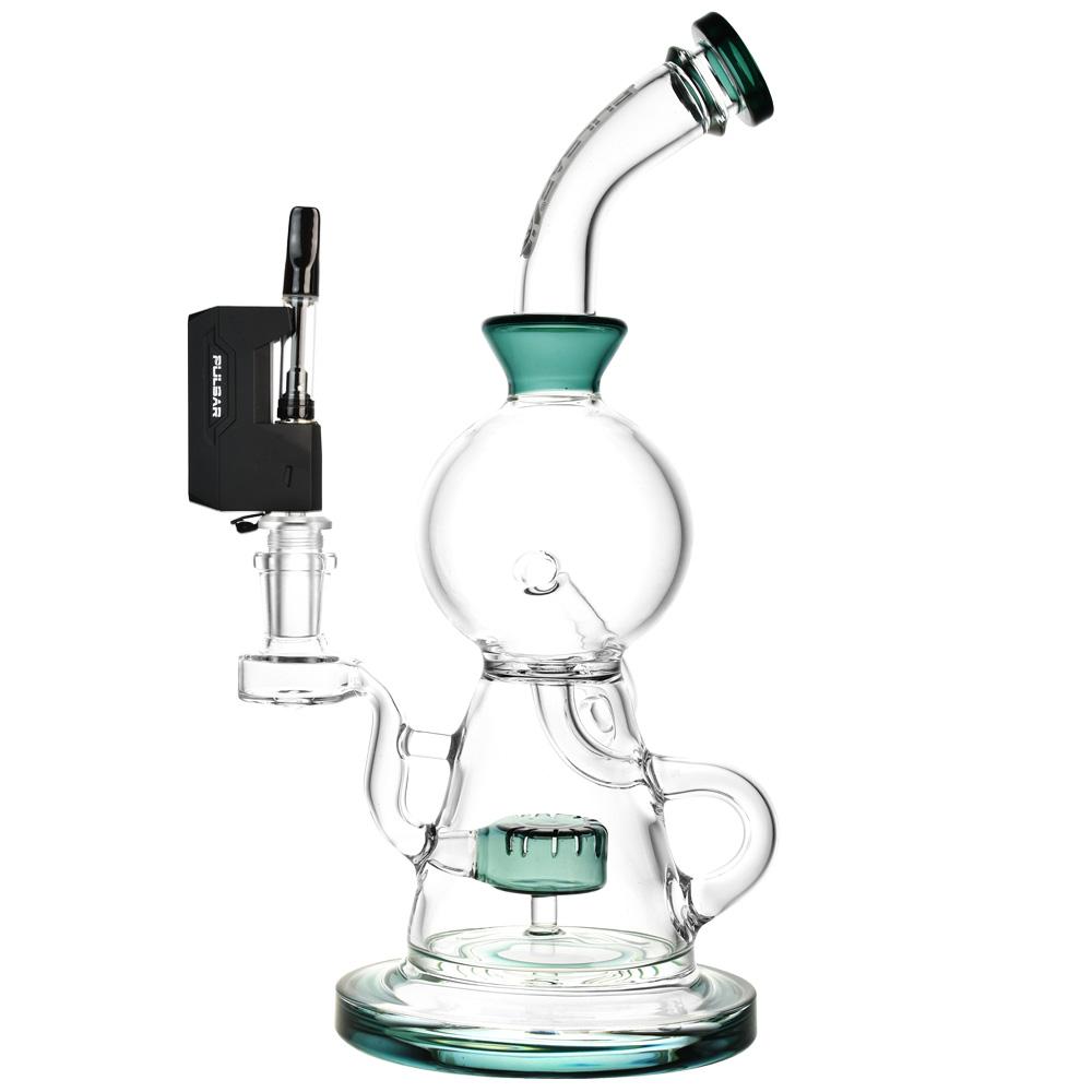 A real-world demonstration shot showing the Pulsar GiGi H2O 510 vape battery in Matte Black fully installed onto a glass bong. A clear 510 oil cartridge is threaded into the top of the battery, while the bottom of the device uses the 14/19mm male adapter to form a tight, flush seal inside the female ground joint of the glass water pipe, illustrating the complete water-filtration setup.