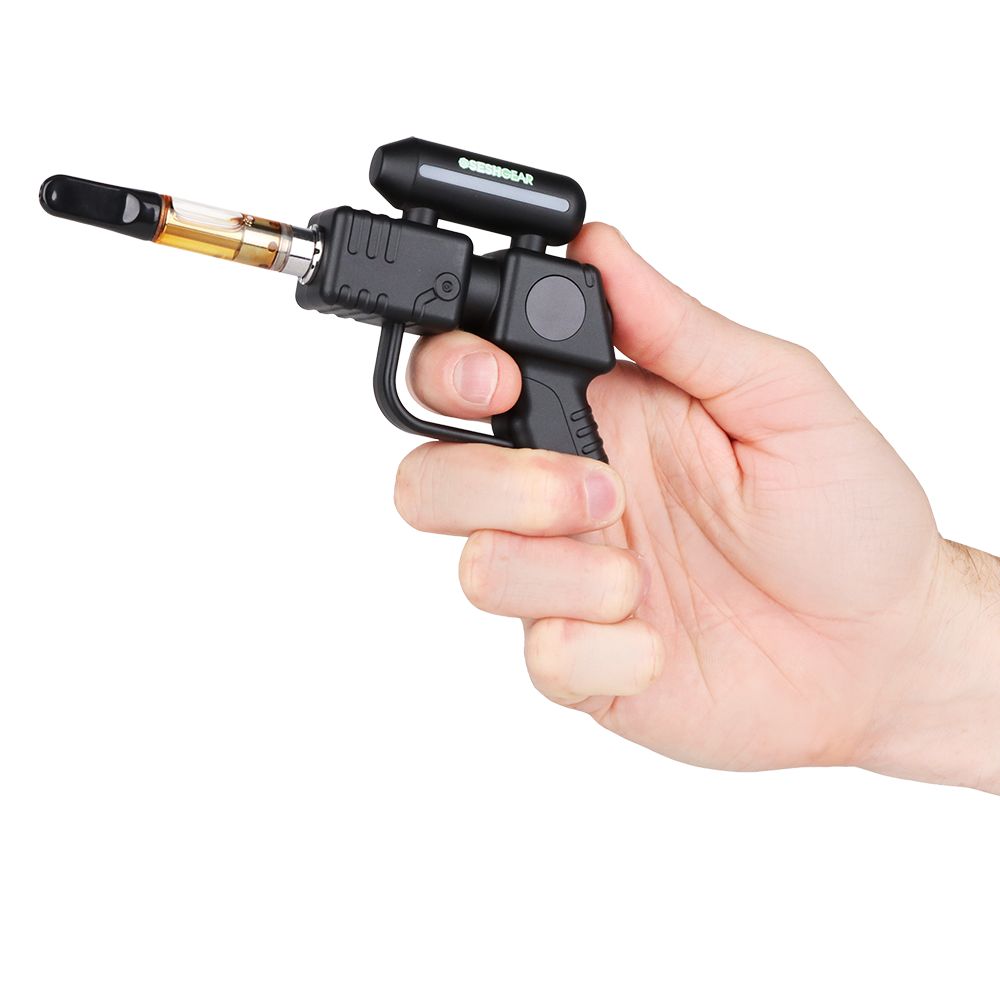 The SeshGear Ray Gun in Black held in hand with a cartridge installed, illustrating the ergonomic "pistol grip" feel and compact size.
