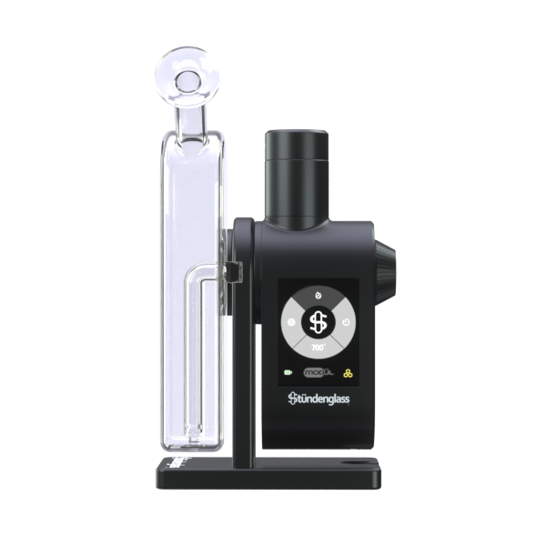 A premium studio product shot displaying the fully assembled Stündenglass Modül + Dok Deluxe Travel Set in Clear Glass standing upright on a clean gray background. Positioned directly next to the elegant, handheld anodized aluminum e-rig is its official hardshell fabric travel case, shown unzipped to highlight its custom-molded protective compartments and rugged drop-resistant build.