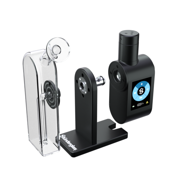 A high-definition, three-quarter angled studio shot showcasing the Stündenglass Modül + Dok Deluxe Travel Set in Clear Glass disassembled in mid-air. The exploded angle highlights the modular separation between the black Modül battery core, the heating tank, the clear borosilicate glass globe, and the anodized aluminum Dok base docking channel.