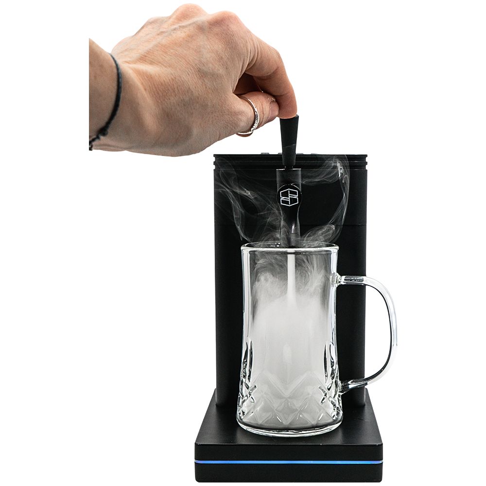 A person's hand pulling the tap handle on the Stache Terp Tap to release vapor into the glass mug.