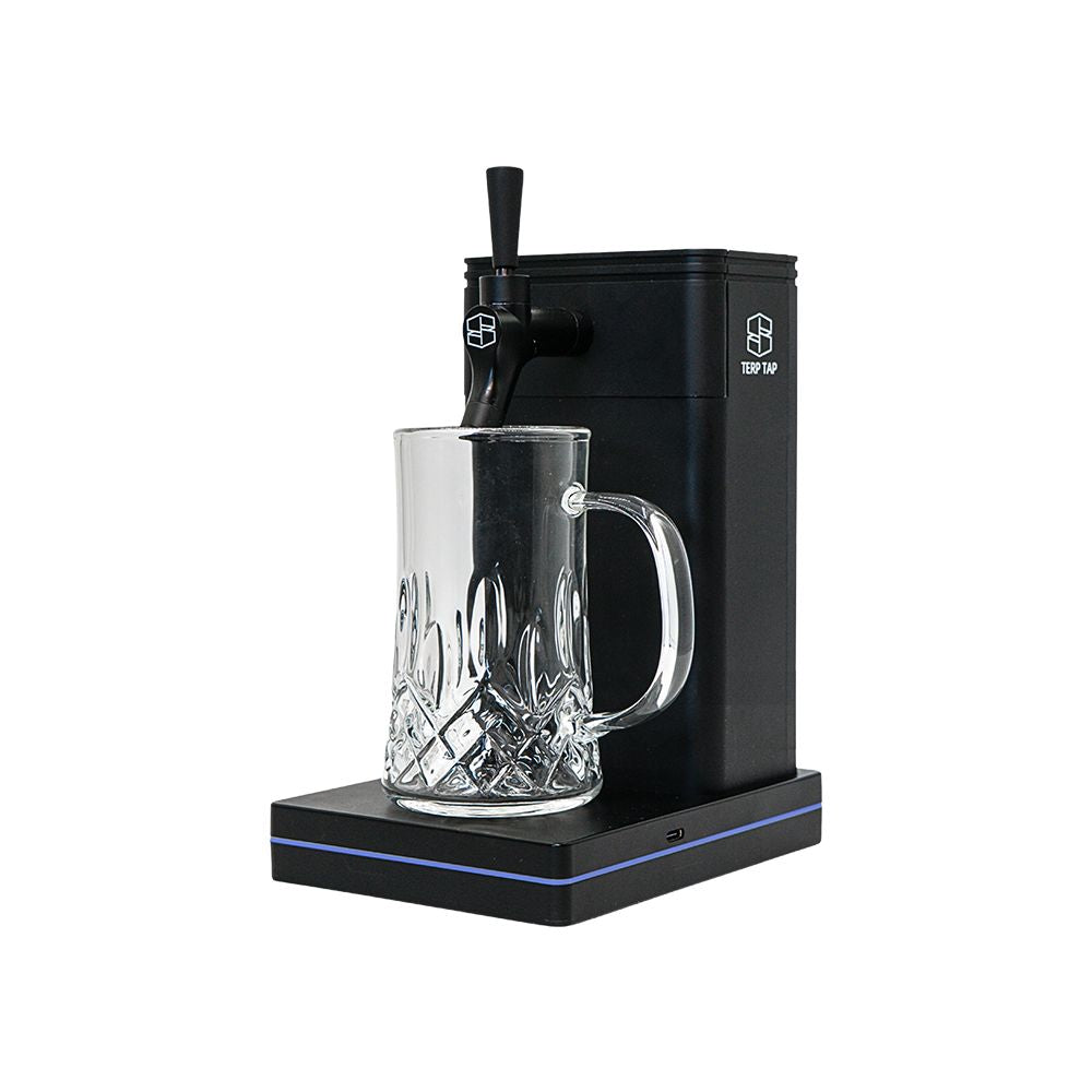 The Terp Tap portable vaporizer by Stache Products shown from a 45-degree angle with a glass mug positioned under the tap-style 510-thread mouthpiece.