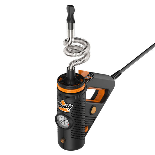 A clean, front-facing studio product shot of the Storz & Bickel Plenty Desktop Vaporizer standing vertically. The premium device highlights its black and bold orange high-grade polymer power-tool aesthetic, featuring the analog temperature wheel at the base, the bright orange trigger handle, and the distinctive double-helix stainless steel cooling coil rising from the top chamber to the black mouthpiece tip.