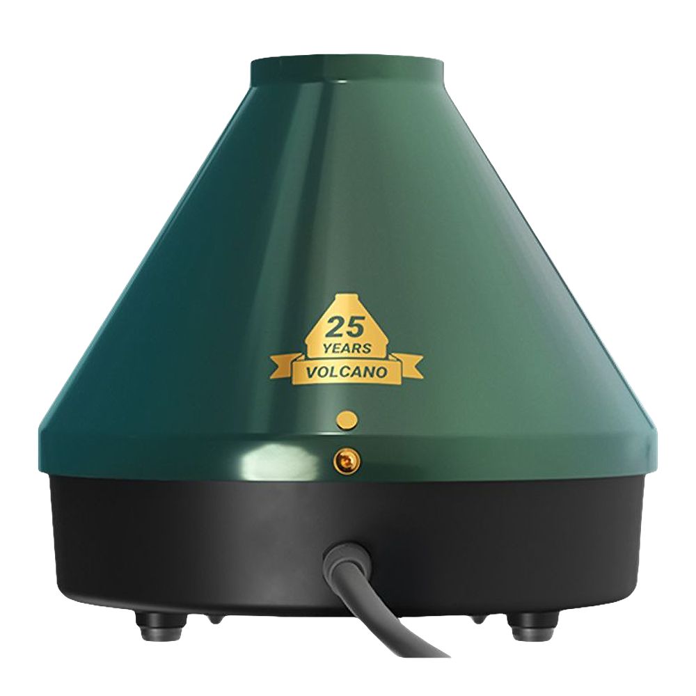 A detailed studio product shot showcasing the rear view of the Storz & Bickel 25-Year Limited Edition Volcano Classic. The shot highlights the seamless, clean curve of the matte emerald green metal outer shell, the heavy-duty black power cord exiting securely from the base, and the rear air intake ventilation grille framed by crisp gold anniversary text branding.