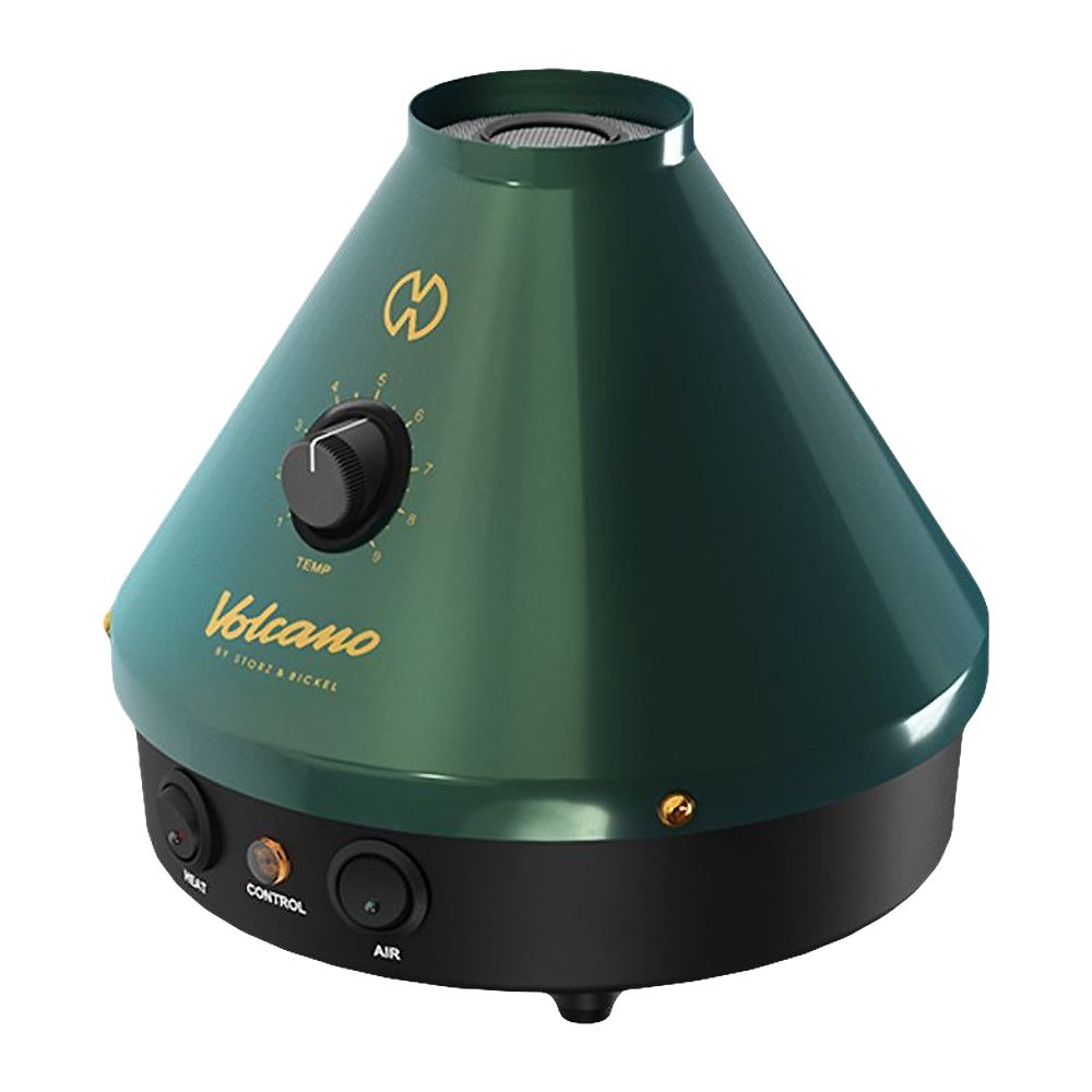 A crisp, studio-angled product shot of the Storz & Bickel Volcano Classic 25-Year Anniversary Vaporizer. The angle highlights the ergonomic placement of the gold-plated temperature dial and central brand badge against the matte emerald green cone, showcasing how the unit's industrial profile looks when placed on a desktop surface.