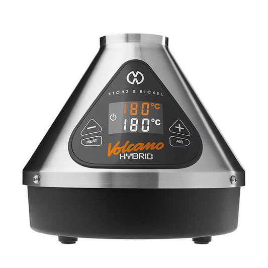 A crisp, front-facing studio product shot of the Storz & Bickel Volcano Hybrid Desktop Vaporizer in the classic Silver finish. The iconic cone-shaped desktop unit showcases its brushed stainless steel exterior shell, the bright blacked-out digital LED touch display panel illuminated on the front, and the high-grade heating core peak at the top on a clean background.
