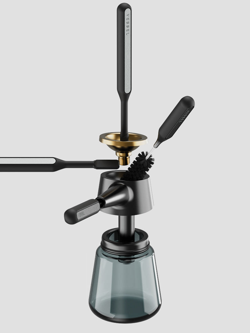 A demonstration shot showing the Vessel Care Kit tools in use with the Vessel Element bubblers. The image highlights how the specialized Spiral Swab and Fine Pick are designed to reach into the intricate glass curves and airpaths of the bubbler, proving the kit's effectiveness for maintaining high-end glass hardware.
