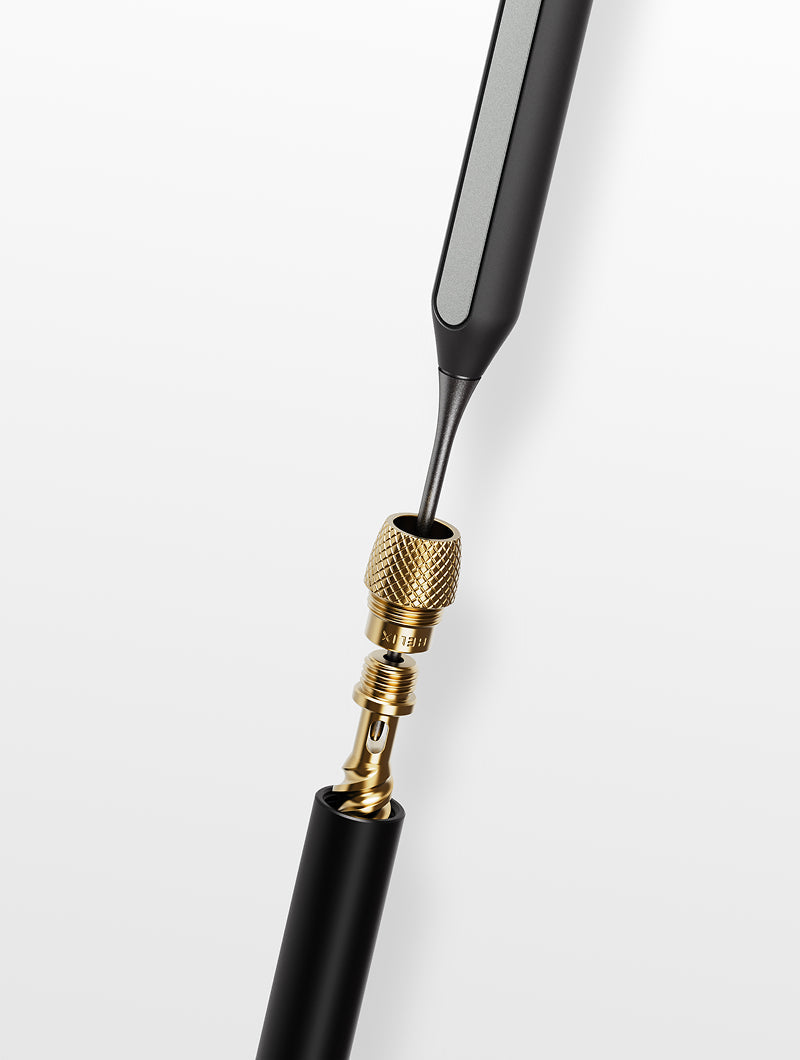 A precision cleaning shot featuring the Fine Pick being used on the internal components of a Vessel Helix pipe. This view showcases how the tool clears stubborn blockages from the specialized double-helix airpath, ensuring the signature cooling effect of the Helix remains uncompromised.