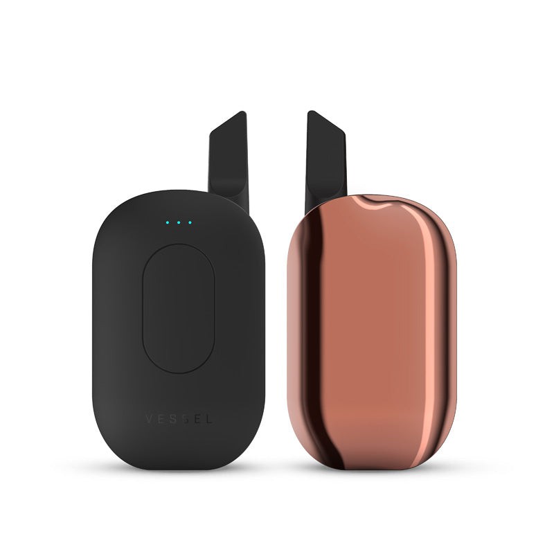 A clean studio product shot displaying two Vessel Compass Copper vape batteries side-by-side for a complete 360-degree layout view. The device on the left faces directly forward, detailing the sleek central control button, the 3-LED array, and an installed 510 oil cartridge. The matching device on the right is turned around, emphasizing the smooth, unibody back panel and the uniform metallic copper finish.