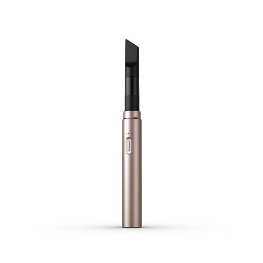 A clean, front-facing studio product shot of the Vessel Core 510 vape battery in Blush. The ultra-slim, compact stick pen stands perfectly vertical, highlighting its smooth, matte pastel pink anodized aluminum finish, the centralized silver power button, the 3-LED indicator array right above it, and the signature wide 510 connection crown at the top housing an installed clear glass oil cartridge.