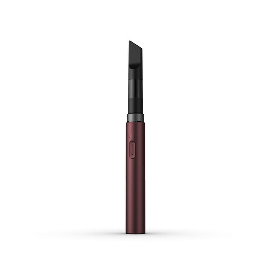 A clean, front-facing studio product shot of the Vessel Core 510 vape battery in Merlot. The ultra-slim, compact stick pen stands perfectly vertical, highlighting its smooth, rich red anodized aluminum finish, the centralized silver power button, the 3-LED indicator array right above it, and the signature wide 510 connection crown at the top housing an installed clear glass oil cartridge.