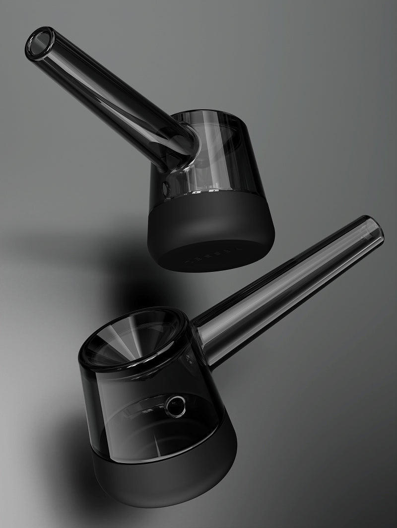 A detailed angled shot of the Vessel Forge in Black. This view showcases the ergonomically sculpted neck and the smooth, hand-finished quality of the heat-resistant borosilicate glass. The deep black silicone base is shown flush against the glass, highlighting the seamless integration and surface-protecting design.