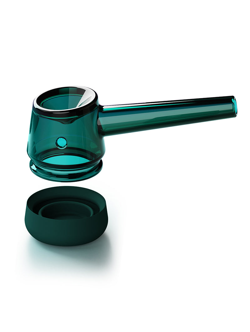 A detailed shot of the Emerald Vessel Forge with the borosilicate glass pipe removed and hovering directly over its removable silicone base. This view clearly demonstrates the modular, two-piece construction designed for effortless cleaning and maintenance.