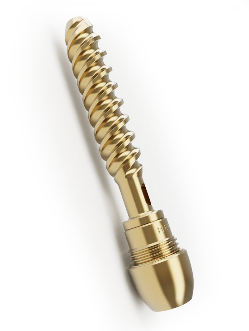An angled profile shot of the Vessel Helix Axis and its double helix core laying down. This view emphasizes the polished, precision-cut finish of the non-toxic brass and the substantial, weighted design of the Axis bowl compared to the cooling core.