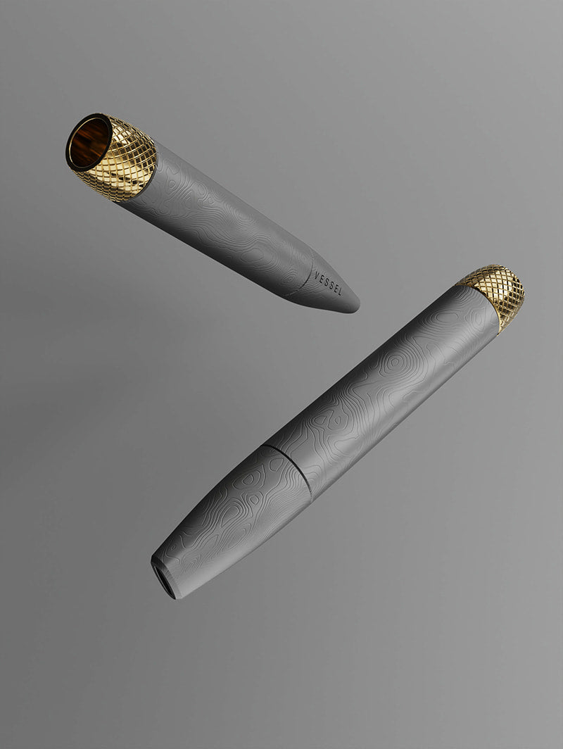 A duo of Vessel Helix Stone pipes shown from two different angles. This perspective illustrates the ergonomic tapering of the body and how the light catches the matte Stone finish, emphasizing its modern and discreet design.