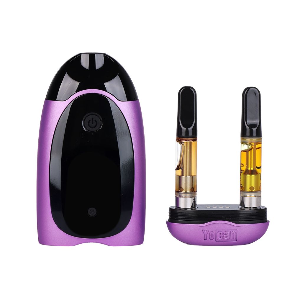 Yocan Dubb 510 Dual Vape in Purple with cartridges removed, showing the inner 510-thread ports, the removable magnetic cartridge bay, and the digital display interface.
