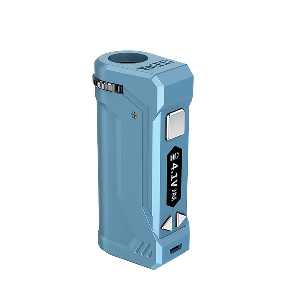 A front-profile view of the Yocan UNI Pro in Airy Blue. This variant is shown in a soft, sky-blue matte finish. The image emphasizes the ergonomic placement of the firing button and the 0.1\text{V} adjustment keys, along with the top-mounted aperture dial for universal cartridge fit.